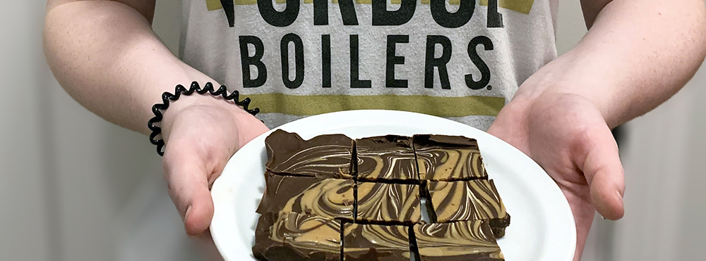 student holding plate of fudge